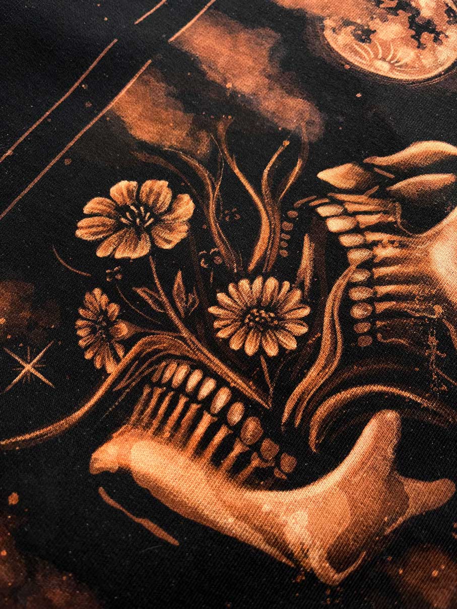 Hand-painted bleach art wall hanging of the Death tarot card, featuring a skull, moon and moth, wood dowel frame with black fringe