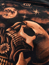 Hand-painted bleach art wall hanging of the Death tarot card, featuring a skull, moon and moth, wood dowel frame with black fringe