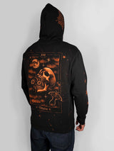 A person wearing a black pullover hoodie with a large gothic tarot card style graphic on the back featuring a skull, moon, stars, and the word 'Death,' shown against a light gray studio background.