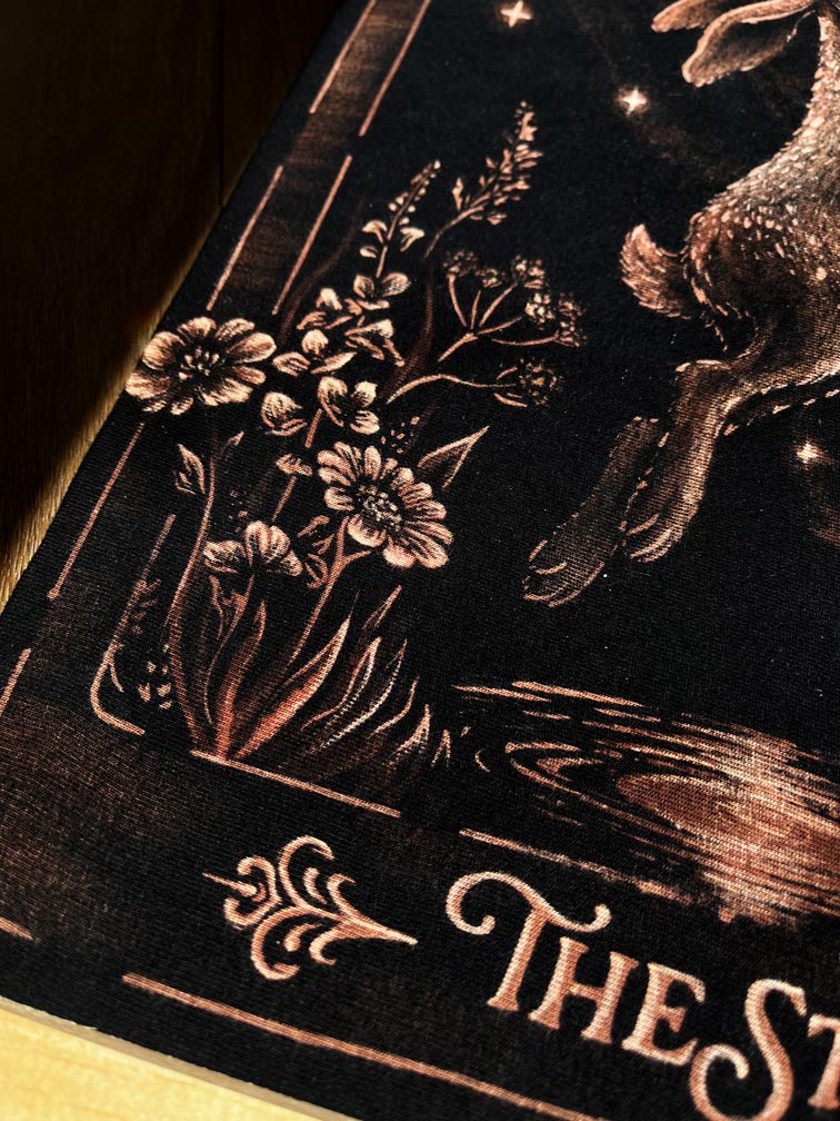 Hand-painted bleach art wall hanging of The Star tarot card, featuring a hare reaching toward a star, wood dowel frame with black fringe