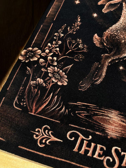 Hand-painted bleach art wall hanging of The Star tarot card, featuring a hare reaching toward a star, wood dowel frame with black fringe