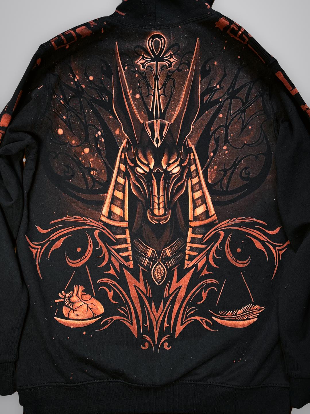 Flat lay of the Anubis hoodie back, showing Anubis with the ankh and the scales weighing a heart against a feather