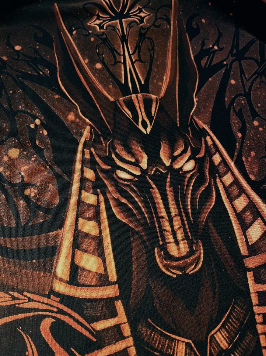 Close-up of the hand-painted Anubis head in copper bleach on black fabric