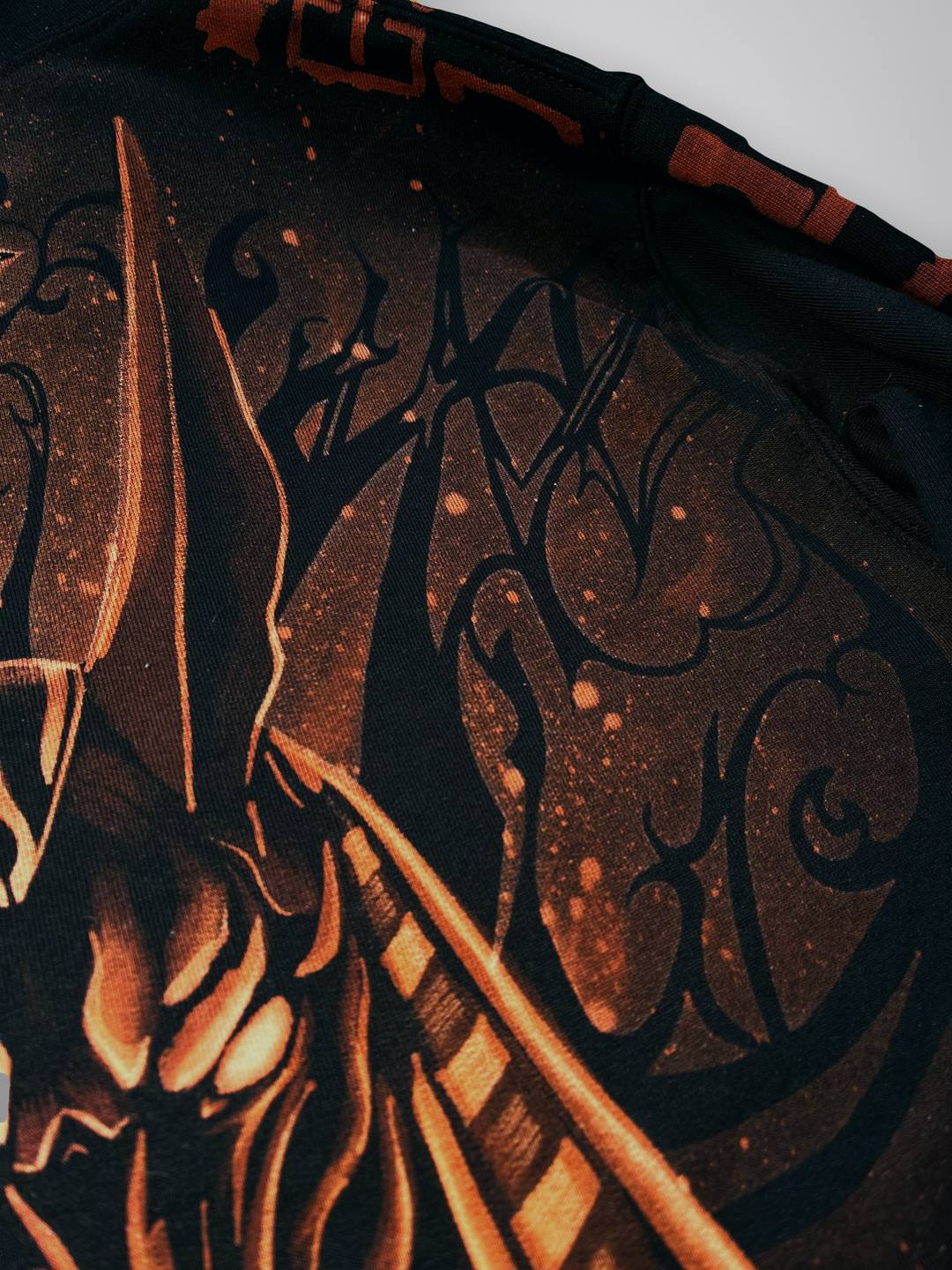 Close-up of the bleach-painted linework and splatter texture on the back of the Anubis hoodie, with hieroglyphs on the sleeve