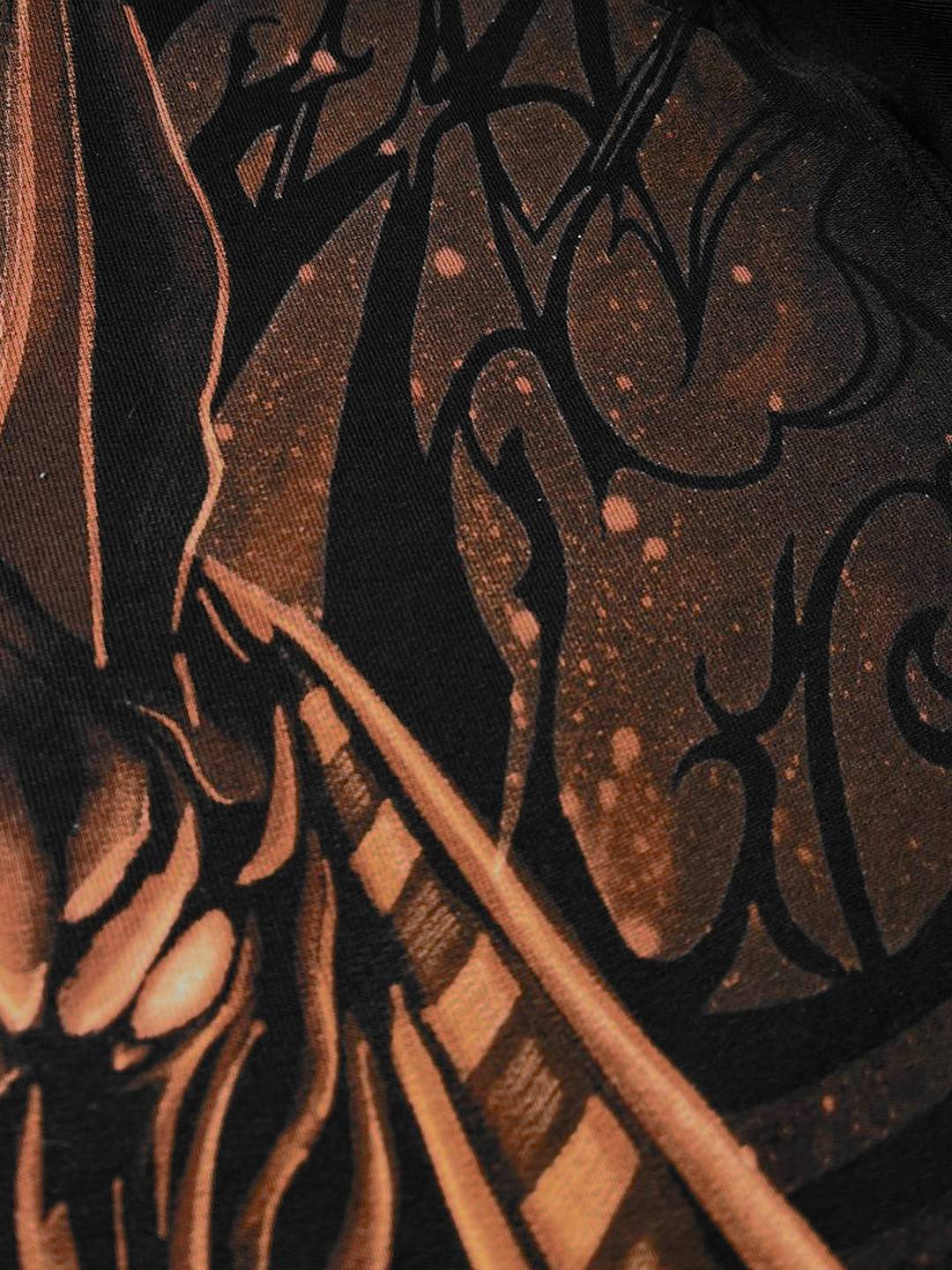 Close-up of the bleach-painted linework and splatter texture on the back of the Anubis t-shirt