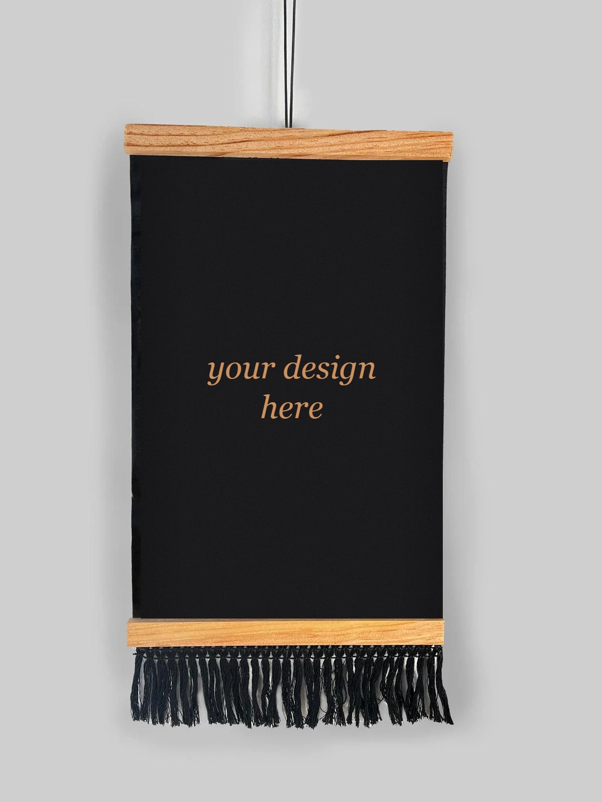 Custom bleach-painted wall hanging on black fabric with natural wood dowels and black fringe trim, with 'your design here' in the center