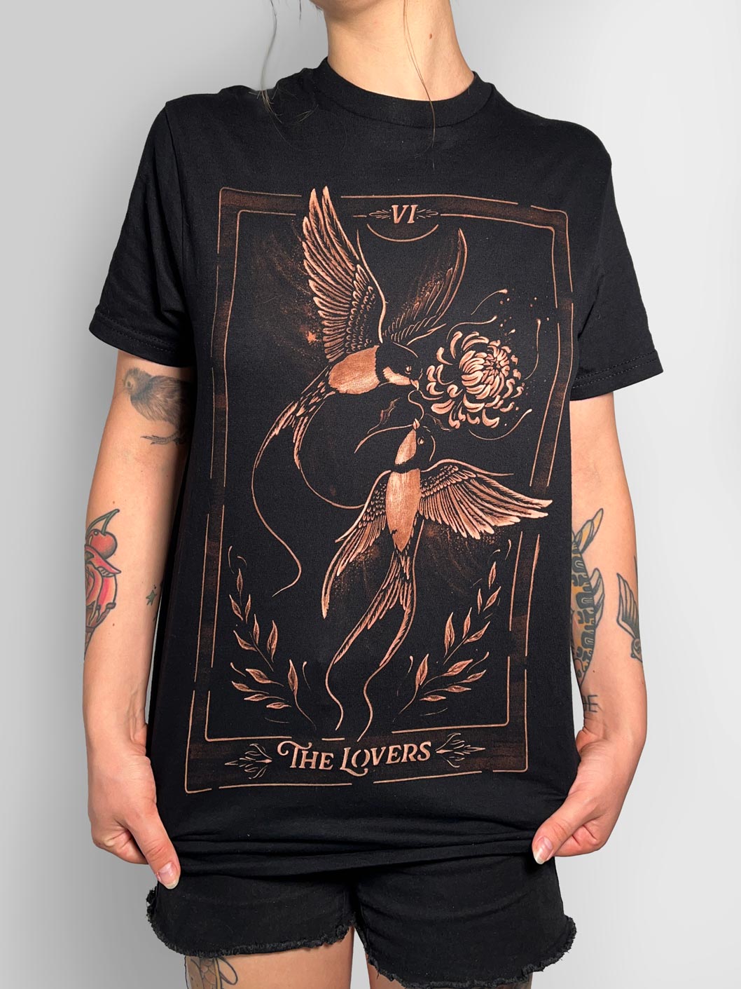 Hand-painted bleach art t-shirt of The Lovers tarot card, featuring two birds in flight sharing a flower